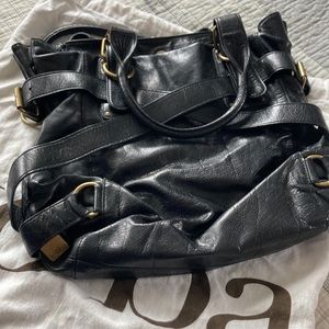 Original Kooba with duster black leather strappy tote with adjustable sides.